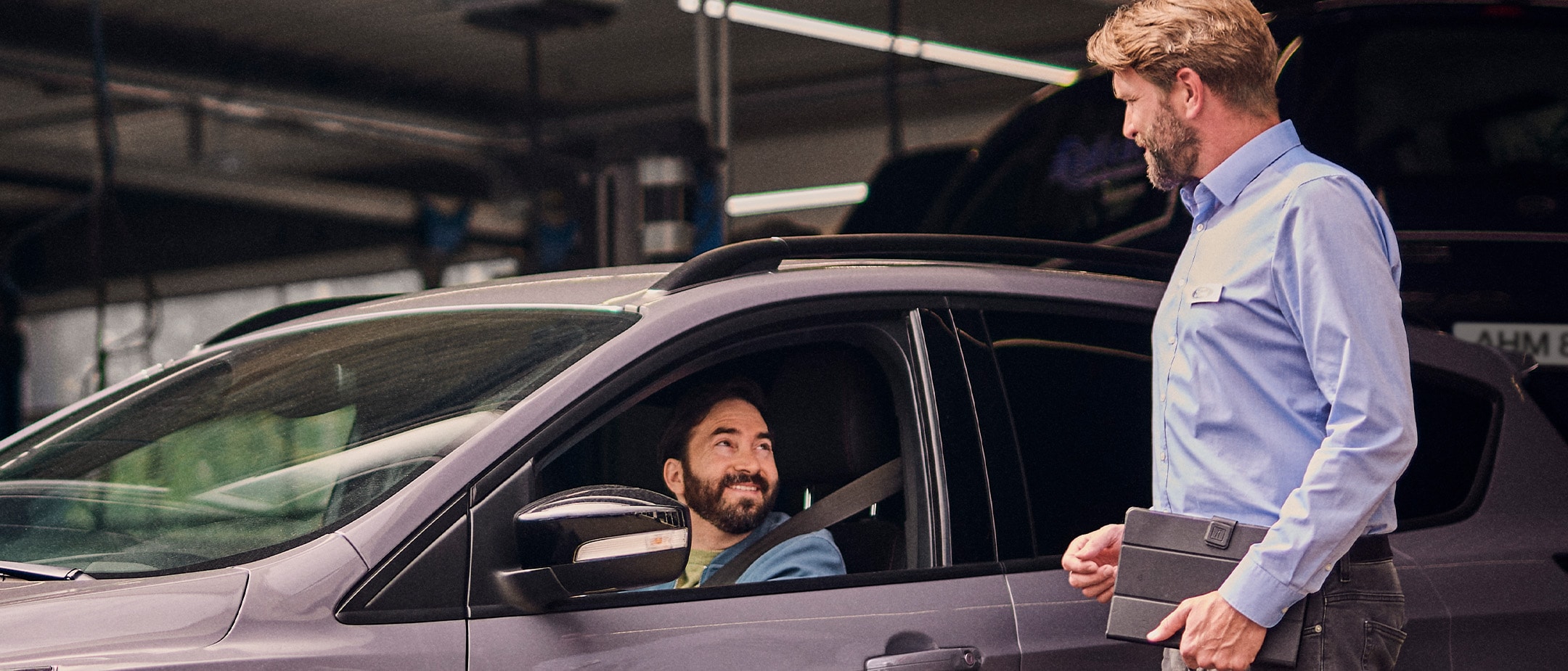 Man sitting in a car and talking to someone